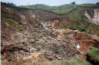 Labourers work at a mine near the town of Rubaya