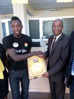 Enoch Donkor CEO of Global Access receives a certificate of appreciation from Afcon 2015 Beach Socce