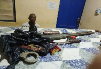 The suspect with a display of items found in his bag