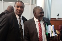 Mr Elioda Tumwesigye (left), who was thrown out of Parliament, interacts with the petitioner