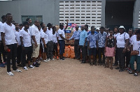 Management and staff of Opportunity International with some of the students