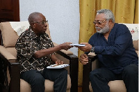 Samuel Ntim Darkwa presenting the book to former President Jerry John Rawlings