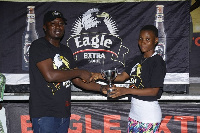 Brand Manager of Eagle Extra Stout, John Akado presenting to Grace Commey