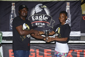 Brand Manager of Eagle Extra Stout, John Akado presenting to Grace Commey