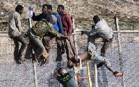 Some migrants seen, trying to cross a border