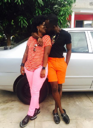 Okyeame Kwame and his wife loved up in a kiss