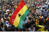 A Ghanaian holding the country's flag