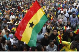 A Ghanaian holding the country's flag