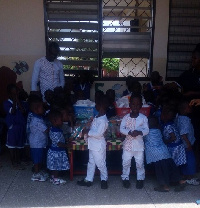 Mr John Akutam in group photograph with some of the orphans