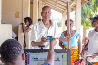 One of the beneficiaries showing his card after registering