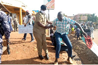 Gulu DPC Emmanuel Mafundo arrests Aruu county MP Samuel Odonga Otto during a protest on June 1, 2020