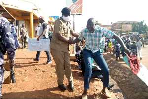 Gulu DPC Emmanuel Mafundo arrests Aruu county MP Samuel Odonga Otto during a protest on June 1, 2020