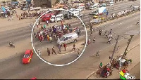 Pedestrians dangerously crossing the N1 road at the Lapaz traffic intersection