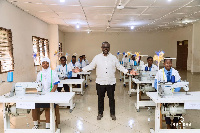 Francis Asenso-Boakye with some students behind the industrial machines