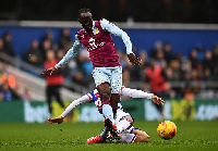 Albert Adomah of Aston Villa is tackled by Massimo Luongo of Queens Park Rangers