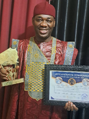 Dr Abdul Razak Toure displays his award from Niger