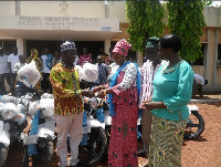 The MP donating the motorbikes to the DCE of Tolon