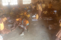 Pupils packed in a classroom without adequate furniture