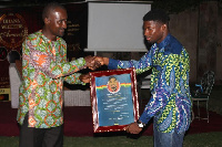 Mr Adjei Agyei Baah (left), presents a citation to Bawa Sadique Anyame