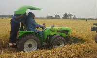 President John Mahama riding a tractor