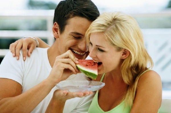 Couple eat watermelon