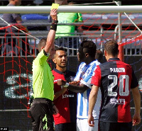 Referee issues a red card to Sulley Muntari