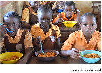 Children enjoying the school feeding meals