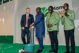 Dr. Mahamudu Bawumia flanked by officials of Olam Ghana