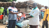 The Assemblyman (in stripped lacoste) handing the items to the  Landlord of Namolo