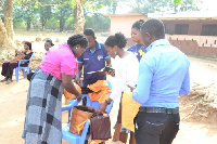 Irene Adjei making the presentation to the school