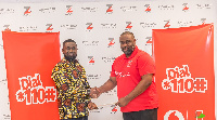 Martison Obeng-Agyei, Head of Vodafone Cash in a hand shake with Kwame Adadey