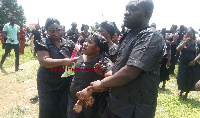 Maa Lydia, the wife of the late Isaac Adu Botwe being consoled by some family memebers