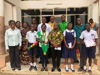 Winifred Korangye Amoah with her parent, some students and  teachers in a group photo with the MCE