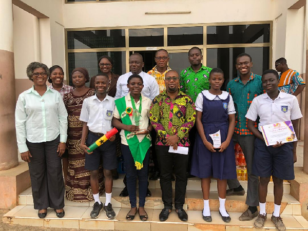 Winifred Korangye Amoah with her parent, some students and  teachers in a group photo with the MCE