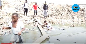 The young man lost his step and feel into the waste filled lagoon.