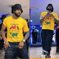 Usher having fun wearing his yellow 'Gye Nyame' shirt