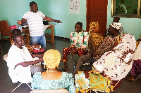 Some parents having a talk with experts on SGBV