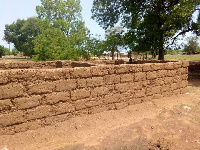 Community members are putting up a brick house for a newly posted nurse