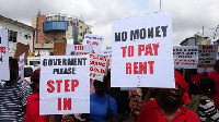 Mengold customers holding placards during a demonstration