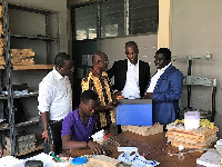 Director of PRAAD, Felix Ampong (3rd from right) briefing Origin8 during the visit