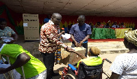 MCE, Hon. Frank Okpenyen present package to person with disability