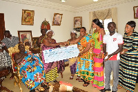 Samara group presenting cheque to Okyehene