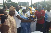 Dr Sharubutu presenting the silverware to the captain of Ashaiman Zongo