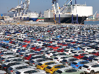 Cars to be exported sit at a terminal in the port of Yantai, Shandong province, China