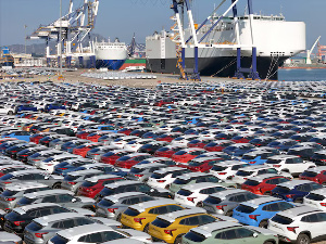 Cars to be exported sit at a terminal in the port of Yantai, Shandong province, China