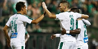 Mubarak Wakaso celebrating with his Panathinaikos teammates.