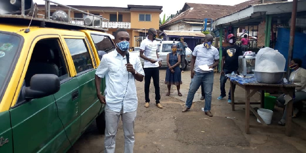 Dennis Edward Aboagye, MCE for the Akuapem-North Municipal Assembly holding a microphone