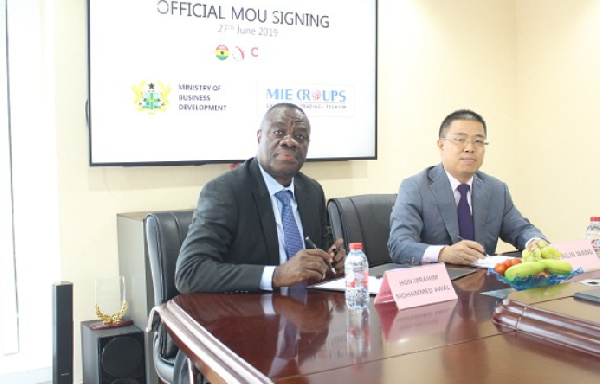 Business Development Minister in a handshake with the Chairman of MIE Groups David Wang