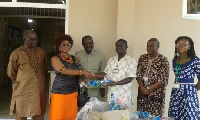 Mr Kobla Quashie, Consul to Swaziland donating to Korle Bu