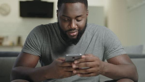 Young Man Pressing Phone